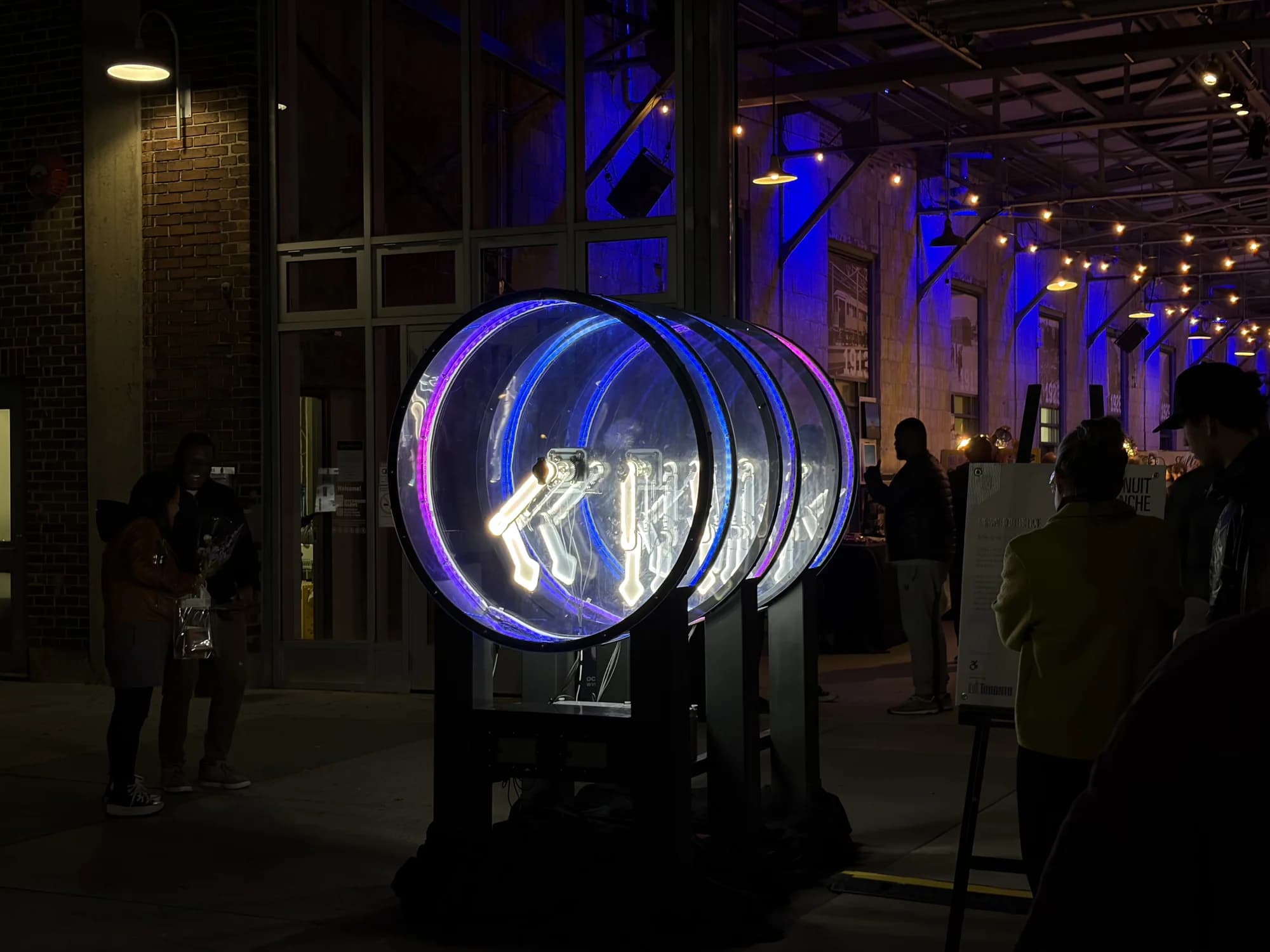 Rhythms of Chaos illuminated in blue and pink during its public exhibition