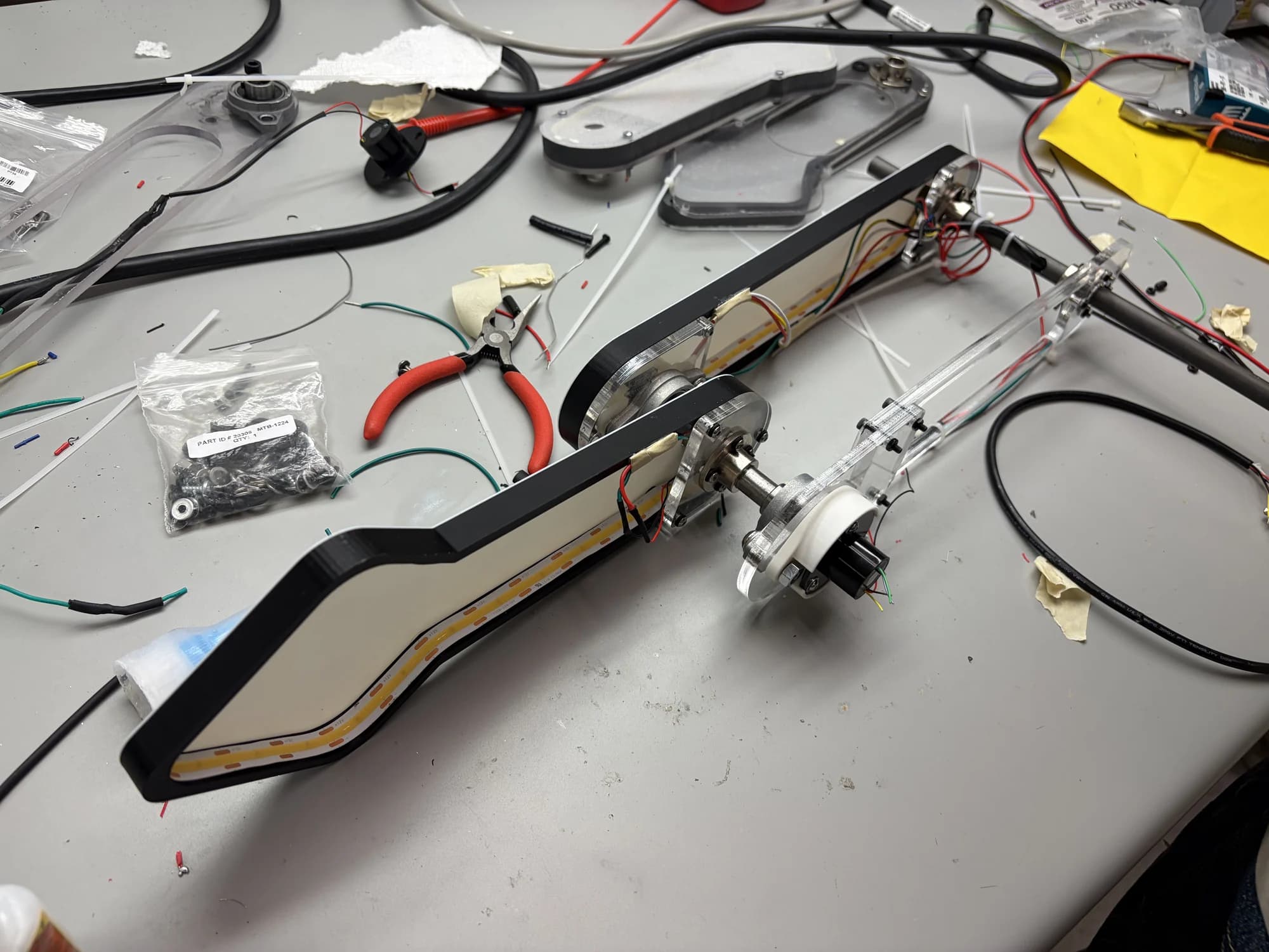 A physical double-pendulum arm during wiring and assembly on the workbench