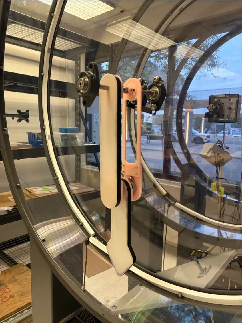 Prototype double pendulum mounted inside the larger circular structure for integration testing